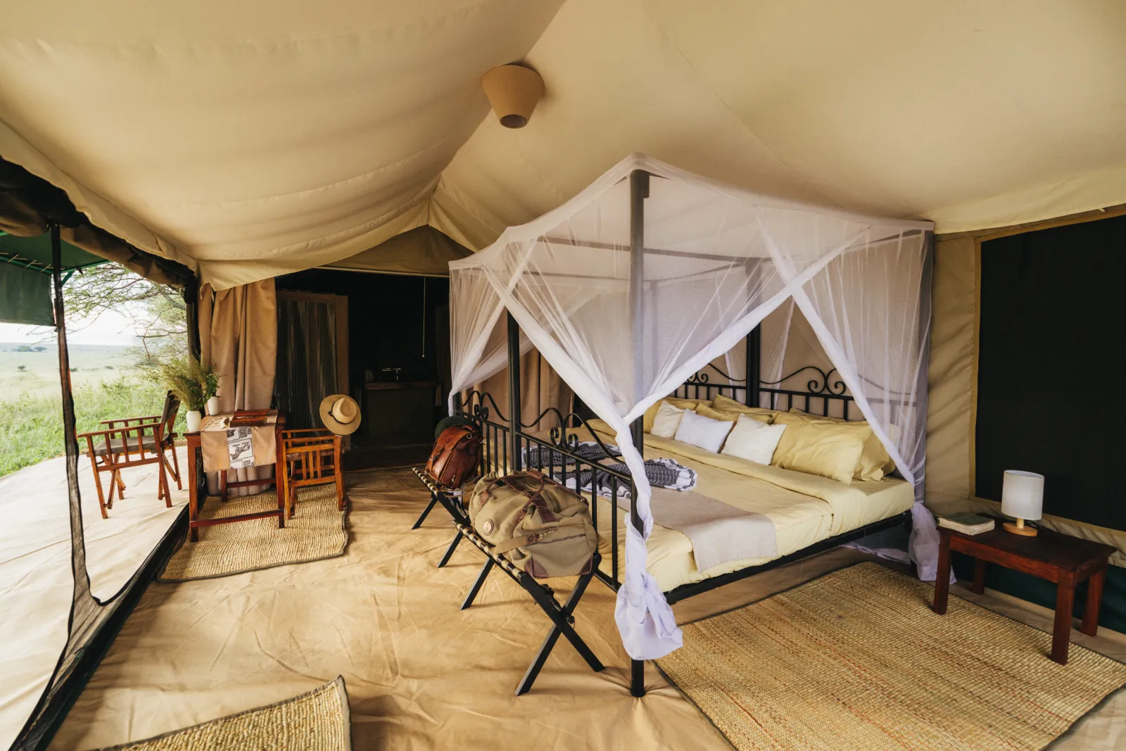 Inside a Serengeti camp tent: a canopy bed with mosquito nets