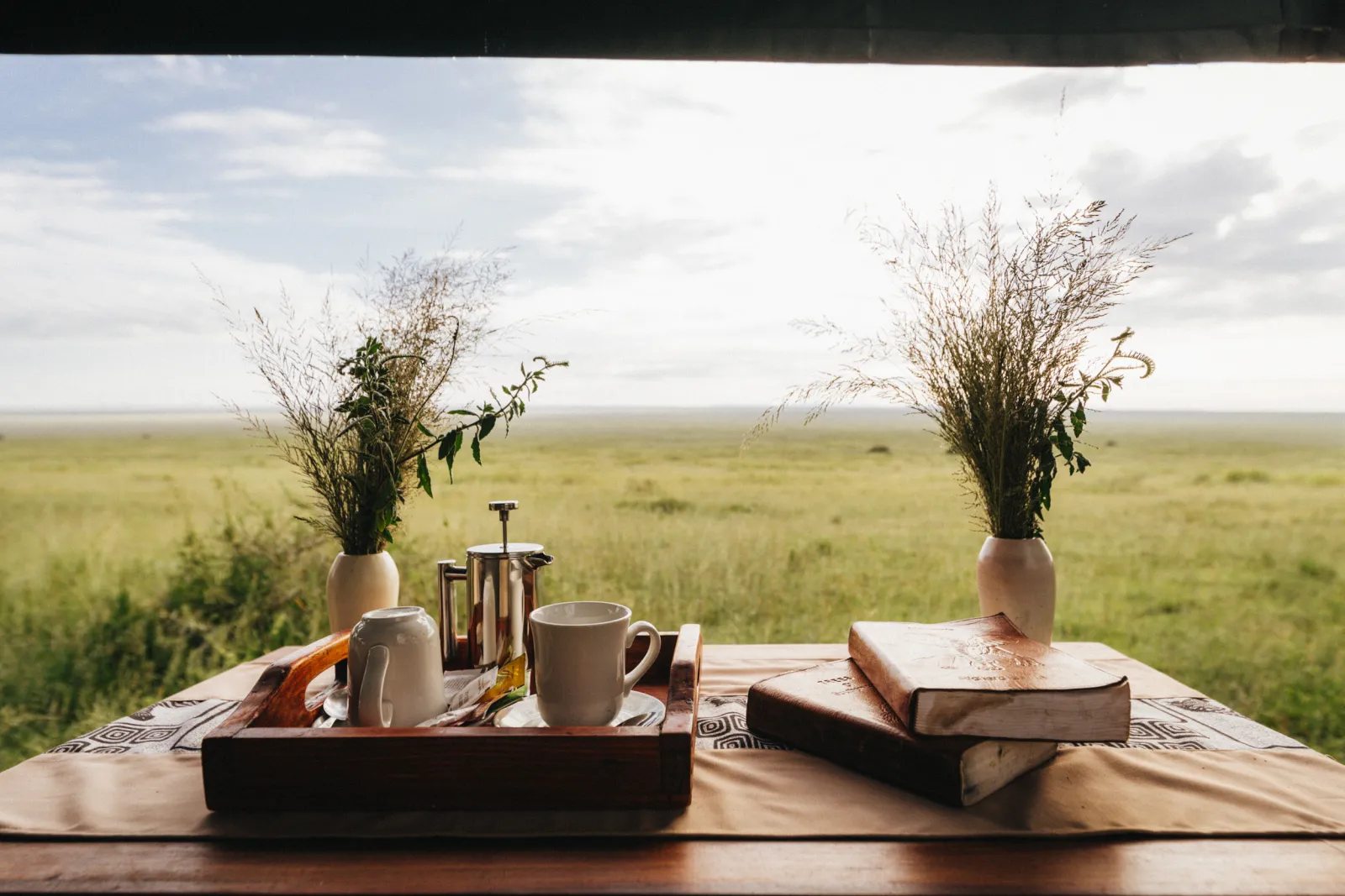 A table set under canvas, open to the plains